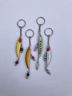 three different colored fish shaped key chains