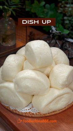 a bowl filled with dumplings sitting on top of a wooden table