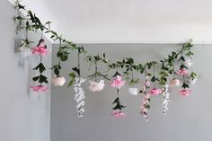 pink and white flowers hanging from the ceiling