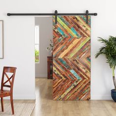 an open door in a room with a wooden floor and wall decoration on the side