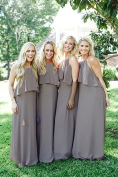 the bridesmaids are posing for a photo in their gray dresses and one is wearing a