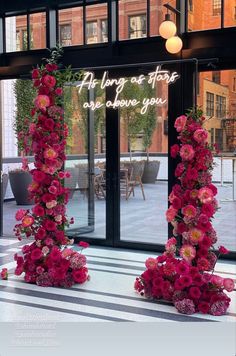 two tall pink flowers are on display in front of a large window with the words, as long as they appear and leave you