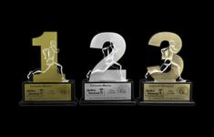 three trophies with the number two on each one and an image of a running man