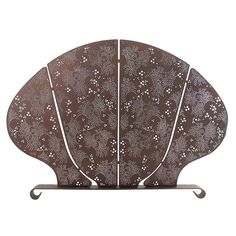 a brown and white fan shaped object on a metal stand with two sides cut out to look like flowers