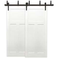 two white sliding doors with black hardware on each side and one door open to the other