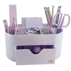 a cup with pens, pencils and other items in it on a white surface