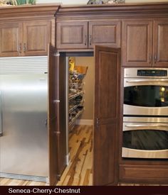 a kitchen with wooden cabinets and stainless steel appliances