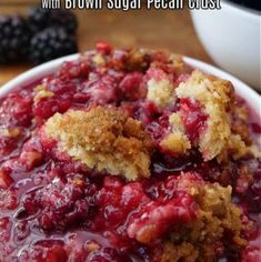 blackberry cobbler with brown sugar pecan crust in a white bowl on a wooden table