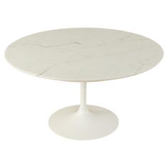 an oval marble dining table with white pedestals and a circular base, on a white background