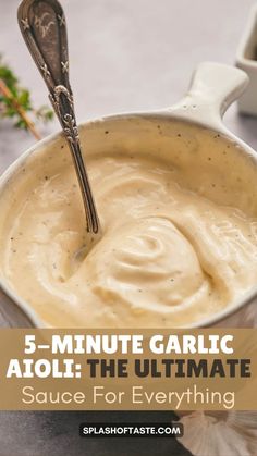 a bowl filled with sauce on top of a table next to a spoon and some parsley