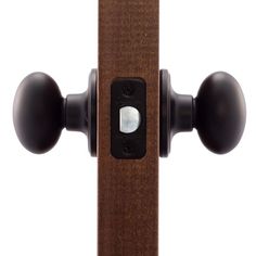 an image of a wooden door handle with black knobs on the front and back