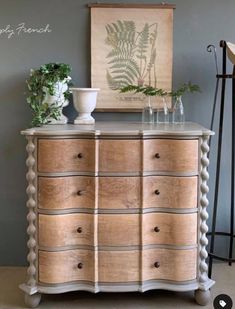 an old dresser with some plants on top