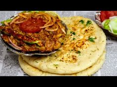 three flatbreads with meat and vegetables on them sitting on top of a newspaper