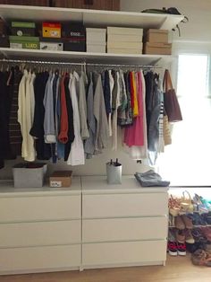 an organized closet with clothes and shoes