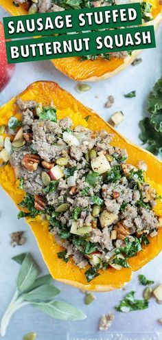 sausage stuffed butternut squash with nuts and kale on the side for garnish