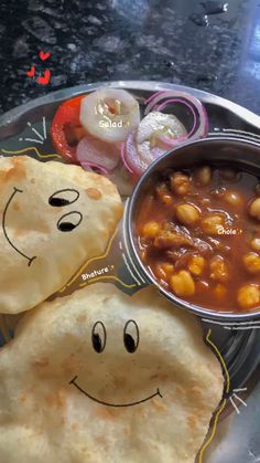 a plate with some food on it and a smiley face drawn on the plate next to it