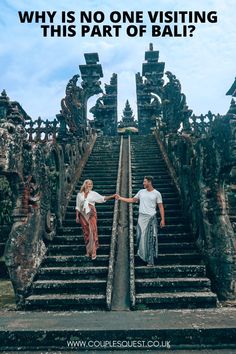 two people walking up some stairs with the words why is no one visiting this part of bali?