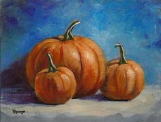 three orange pumpkins on a blue background