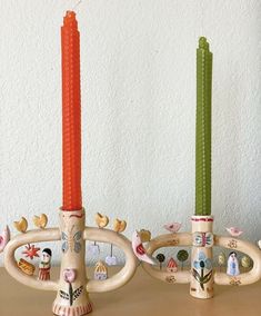 two candles sitting next to each other on a table