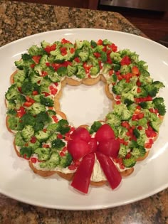 a white plate topped with broccoli and red peppers on top of a counter