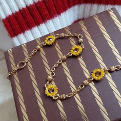 Sweet Sunny Bracelet. A classic to layer your way. 1990's Faux topaz stones, framed within yellow daisy petals. Delicate golden chain accented in fluted beads. Appears to be magnetic. Gleaming gold tone metal. (Not karat gold). This is a small size at 7.5 inches. Lobster clasp. Gift boxed. VINTAGE Retro Gold Jewelry For Gifts, Retro Yellow Gold Metal Jewelry, Retro Metal Jewelry For Gifts, Retro Metal Jewelry For Gift, Retro Gold Jewelry With Adjustable Chain, Yellow Chain Jewelry As Gift, Vintage Bracelets With Adjustable Chain, Retro Jewelry With Adjustable Chain, Retro Necklace With 17 Jewels For Gift