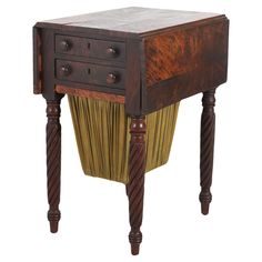 an antique wooden table with two drawers