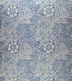 an intricate blue and white wallpaper with large flowers on the left side, and small leaves on the right side