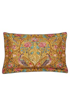 a decorative pillow with an ornate design on the front and back, along with a gold background