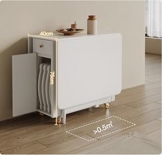 a white cabinet sitting on top of a hard wood floor