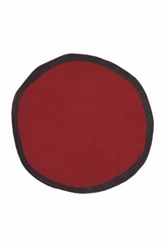 a red and black round rug on a white background with an oval shape in the center