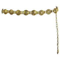 Presenting an incredible gold-tone Gianni Versace chain belt designed by Gianni Versace. From the Spring/Summer 1992 collection, this chic belt debuted on the season's runway in multiple looks and is constructed with gold-tone Versace Medusa logo links. This fabulous Gianni Versace chain belt is an iconic must-have addition to any wardrobe or collection! Approximate Measurements: Length: 34 - 42" Width: 1.25" Medusa Medallion, Versace Chain, Chic Belt, Versace Runway, Draping Fashion, Gold Belt, Gold Belts, Donatella Versace, Christy Turlington