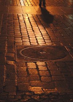 a person walking down the street at night