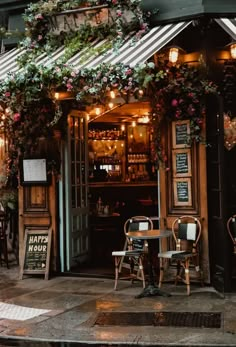 the outside of a restaurant with tables and chairs