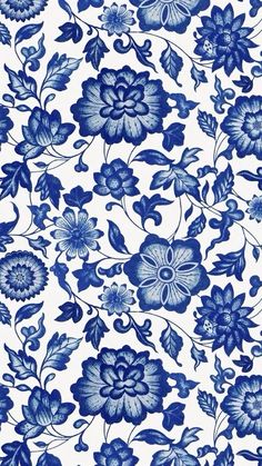 a blue and white floral pattern with leaves, flowers and vines on it's surface