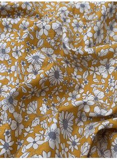 a yellow and white floral print fabric