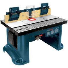 a table sawing machine sitting on top of a blue stand with two blades attached to it