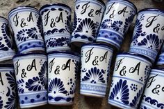 many blue and white cups with writing on them