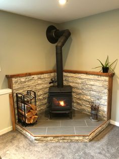 a wood burning stove sitting inside of a living room next to a wall mounted heater