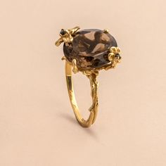 The delicate floral details on this ring surrounds the stunning oval cut smoky quartz to set a statement you didn't know you needed. Approximate stone measurement: 3/8” x 1/2” Finish: 18k gold plated Material: sterling silver, genuine smoky quartz gemstone Item #: 13055 FAIRPRICING $ 115TOORIGINAL | $150 ESTIMATED RETAIL All of our items are priced specially while keeping the same high standard quality. Gold Oval Flower Ring, Smokey Quartz Ring Engagement, Gold Oval Gemstone Flower Ring, Oval Gold Flower Ring With Rose Cut Diamonds, Smokey Quartz Ring, Onyx Engagement Ring, Quartz Engagement Ring, Smoky Quartz Ring, Oval Rings