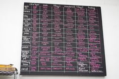 a black board with pink writing on it