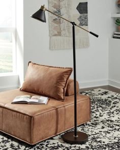 a living room with a couch, lamp and rug