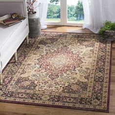 a living room with a large rug on the floor next to a couch and window