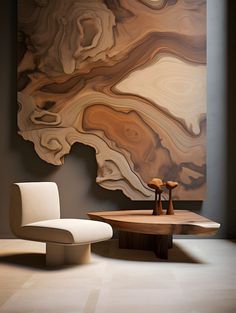 a chair and table in front of a large abstract painting on the wall behind it