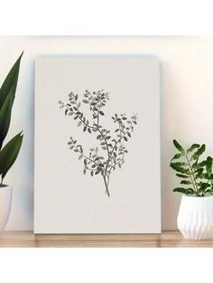 a plant is sitting on a shelf next to a white vase and potted plant