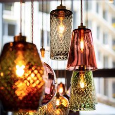 several different colored lights hanging from a ceiling