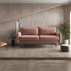 a living room with a pink couch and chair