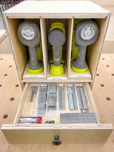 an open drawer with several different tools in it, including drillers and screwdrivers