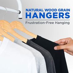 a person is trying to hang clothes on a rail with the words, natural wood grain hangers frustration - free hanging