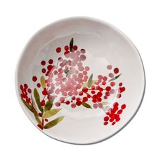 a white bowl with red and pink flowers painted on it