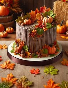 a cake decorated with fall leaves and pumpkins